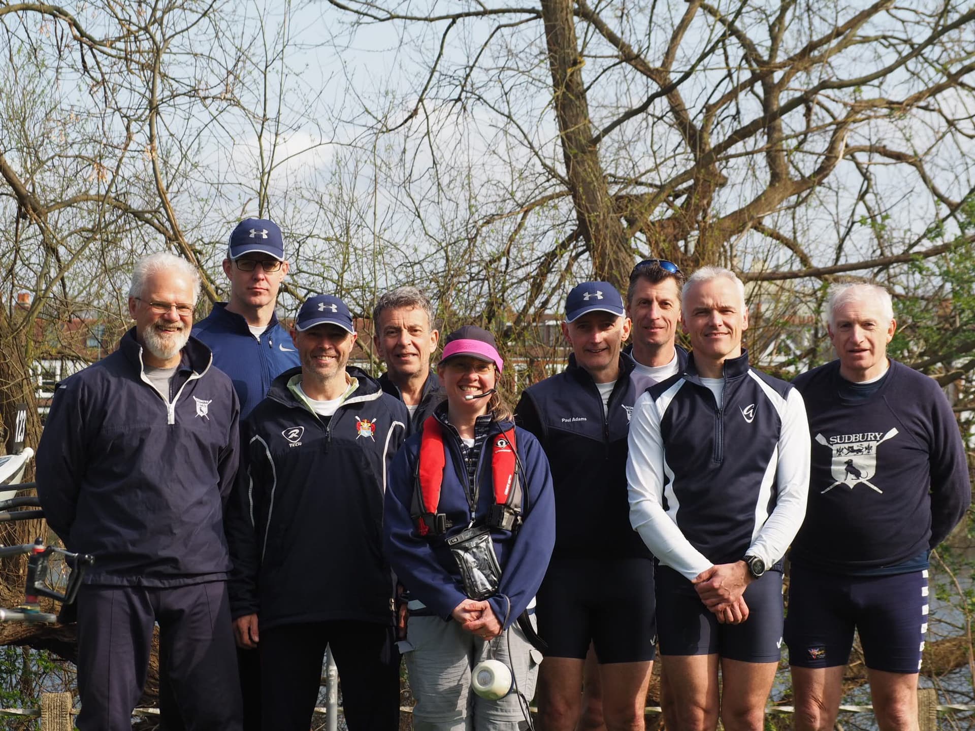 A Sudbury eight crew and cox pose for a post-win photo.