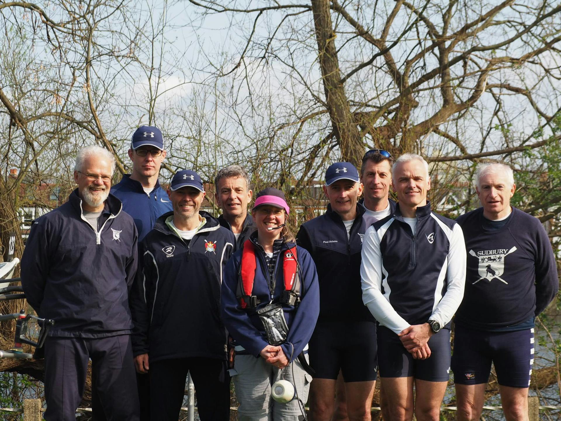 A Sudbury eight crew and cox pose for a post-win photo. 