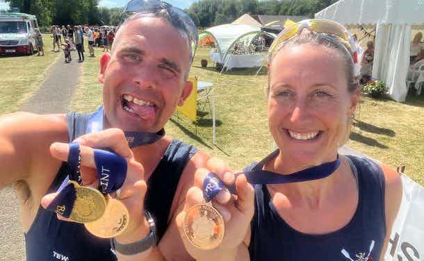 Two rowers show off their medals at a very warm regatta in the East Midlands. 