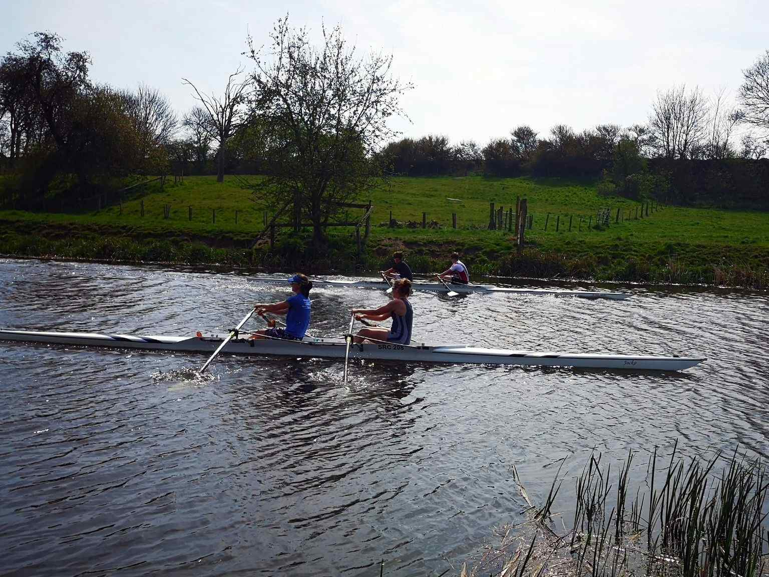 Two doubles approach the finishing post during the Good Friday opening races. 